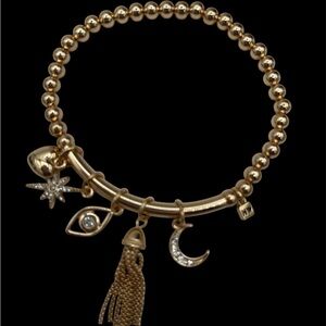 Nine West Gold Tone Tassel, Heart. Star, Moon, Evil Eye Charm Stretch Bracelet